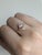 This stunning ring features a 1.11 carat intense fancy pink sapphire in a graceful pear shape, surrounded by ethically...
