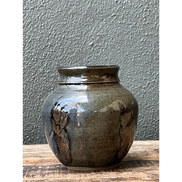 This vintage glazed stoneware vase is a refined example of mid-century studio pottery, distinguished by its balanced...