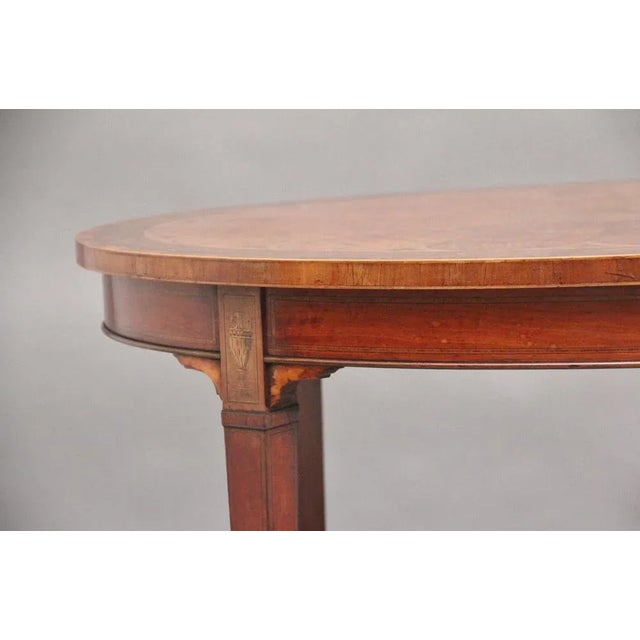 A highly decorative and lovely quality 19th Century inlaid satinwood table in the Sheraton style, the oval top profusely...