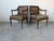 Elegant vintage Louis XVI style armchairs - the pair is accented with removable striped seat cushions, offering a refined...