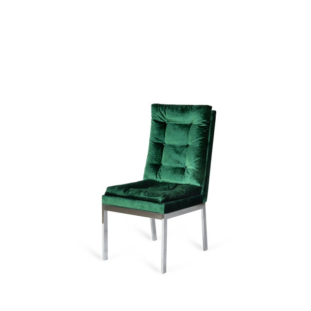 The green velvet upholstered dining side chairs with a chrome frame exude elegance and modern sophistication, seamlessly...