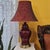 Vintage Chinese flambe porcelain urn lamp featuring a lustrous deep oxblood red glaze, polished brass-tone base, and...
