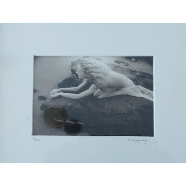 Three magical photos of a young nude on rocks near water. Signed and numbered by Laurie Coppedge. Ms. Coppedge lives and...