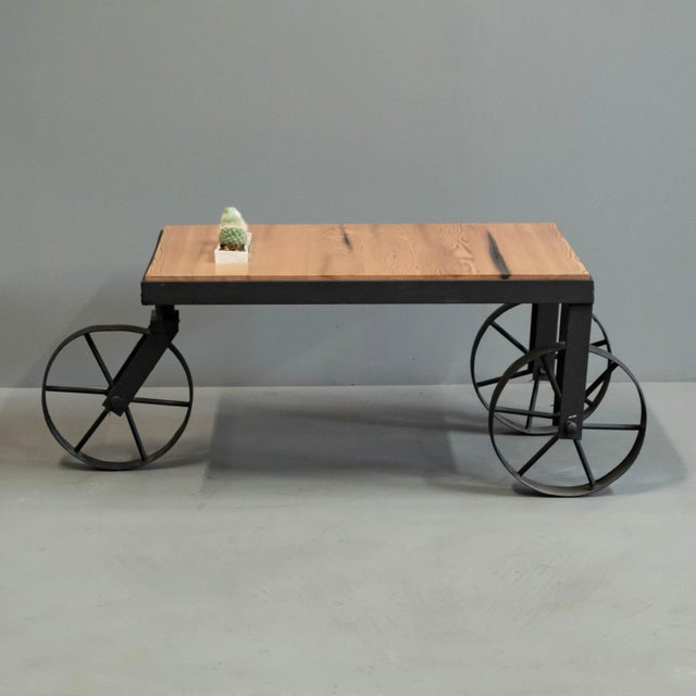 "Farmer Table" custom made by Denver woodworker Jim Guerin. The wheels are found objects that have been powder coated...
