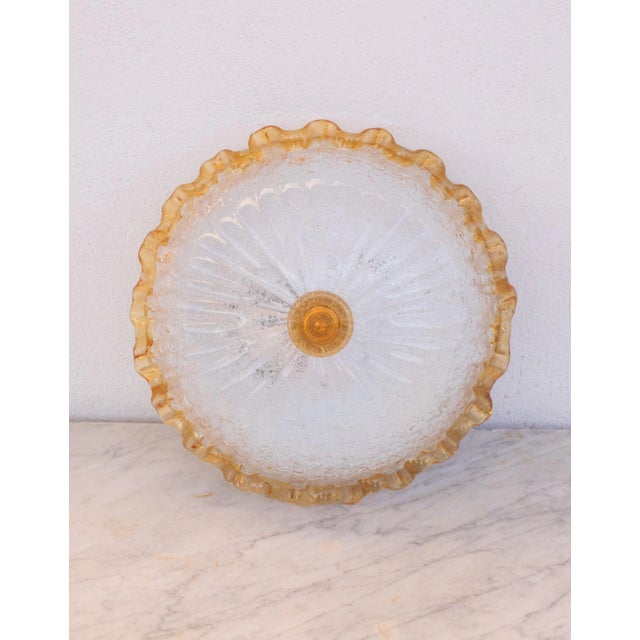 Stunning orange and transparentMurano ceiling light. The ceiling light consists of two glass elements, the central plate...