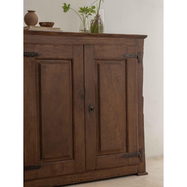 Solid chestnut and poplar sideboard with paneled doors. Original period hinges and storage space divided by a shelf....