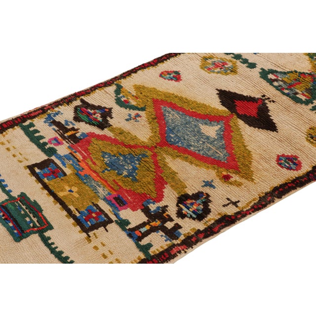 Hand-knotted in wool and originating from Morocco circa 1950-1960, this 3x6 vintage Moroccan rug is an extremely rare...