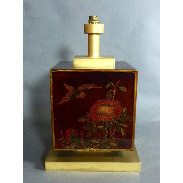 "1970s Lacquer Table Lamp" Brass and lacquer lamp decorated with flowers and birds. There is a signature on the top that...