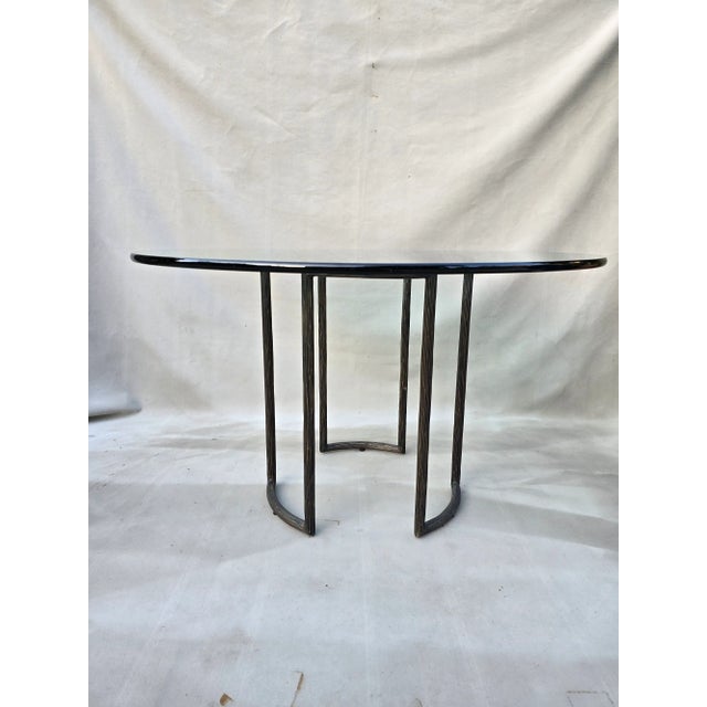 This is a McGuire round glass table from the Thomas Pheasant collection of outdoor furniture. The heavy metal base is...