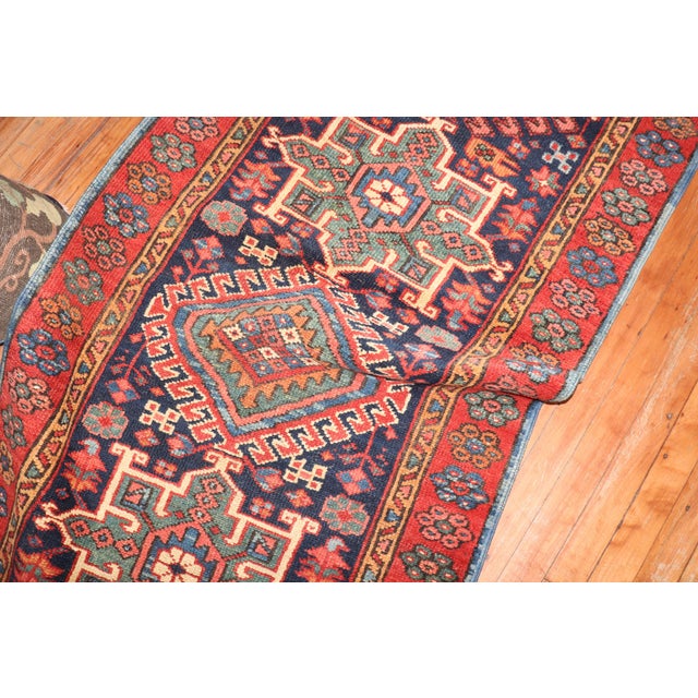 Colorful antique Persian Heriz runner from the 2nd quarter of the 20th century with an all-over geometric motif on a navy...