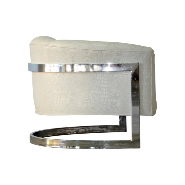 Very large floating cantilever tub chair with chromed steel frame dressed in faux vinyl albino alligator hide upholstery....