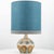 A beige ceramic table lamp with blue and brown accents. Sculptural piece, made of handmade ceramic in fresh tones, with a...