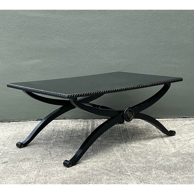 This elegant coffee table is a masterclass in Neoclassical design, featuring a striking Curule-inspired X-base that exudes...