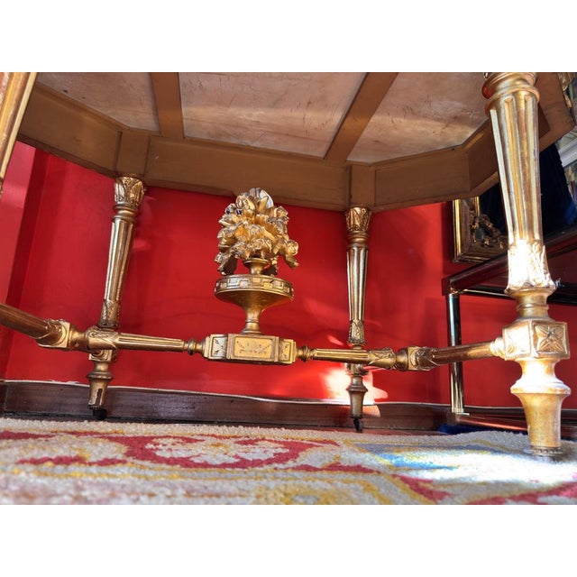 An elegant Napoleon III style console table, crafted from carved and gilded wood, with rich relief decoration of garlands,...