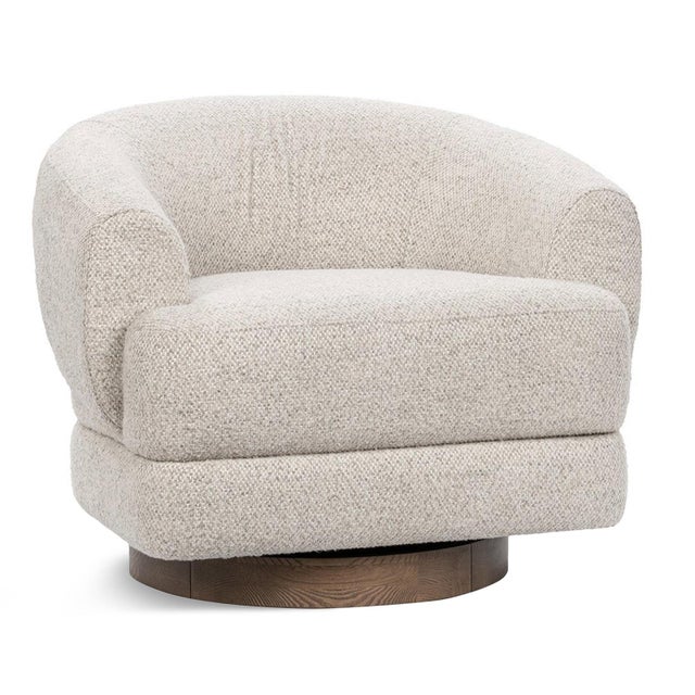 Upholstered swivel accent chair featuring a softly curved barrel silhouette wrapped in a beautifully textured woven fabric...