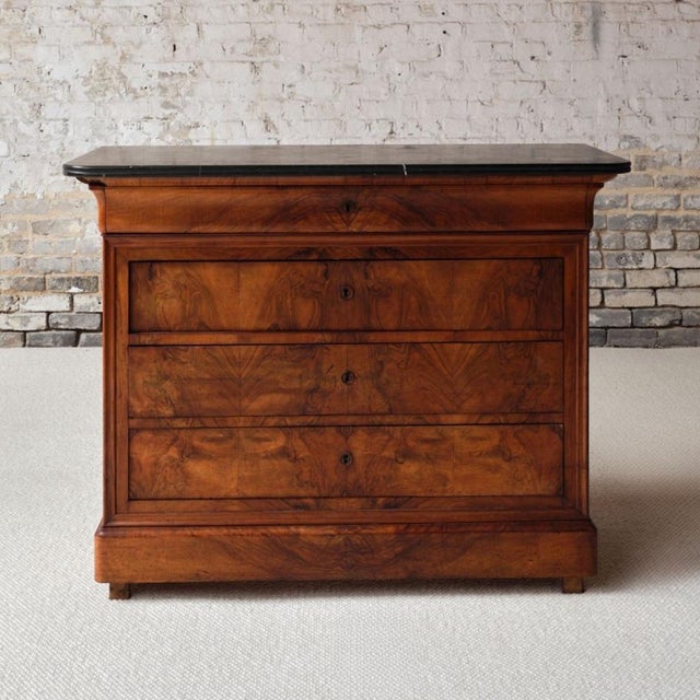 This 19th century French Louis Philippe walnut commode is a beautifully preserved antique chest of drawers, distinguished...