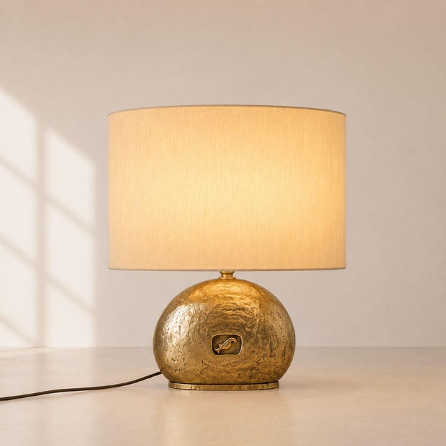 Large Italian table lamp from the 1970s, crafted in massive cast brass and completed with an elegant oval fabric shade....