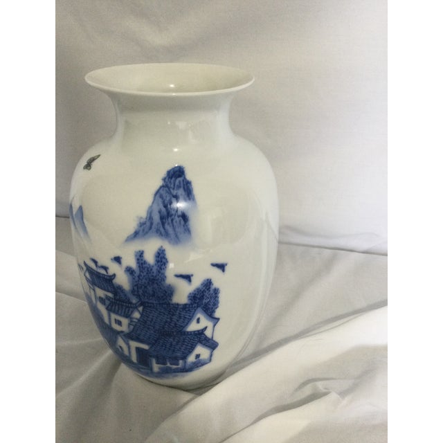 Vintage blue and white vase in excellent condition, featuring a fishing town that tells the story of a coastal place with...