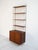 Bookcase with metal uprights, four adjustable teak shelves, and a cabinet with sliding doors. Designed by Nils (Nisse)...