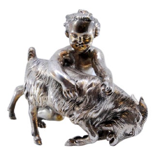 Naked Child with Animal Figurine in Silver For Sale