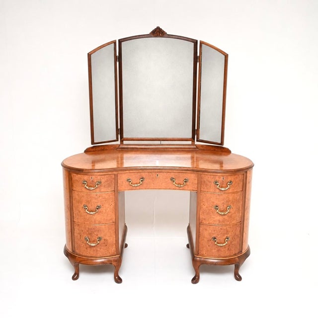 A stunning antique Queen Anne style burr walnut dressing table, made in England by Beresford and Hicks, dating from the...