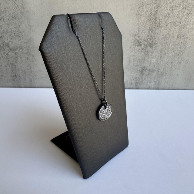 Enhance your jewelry collection with this exquisite Diamond Disc Necklace in 14kt Gold with Black Rhodium Plating....