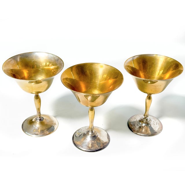 A striking set of three vintage Leonard-style goblets featuring wide, flared gold-tone bowls and elegant silver-tone...
