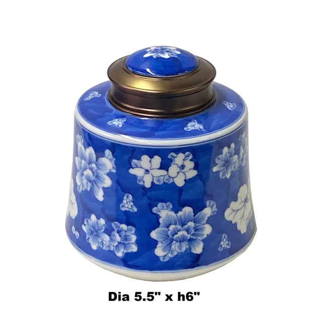 This is a quality handmade porcelain box container urn with a metal lid. The handpainted white color floral graphic...