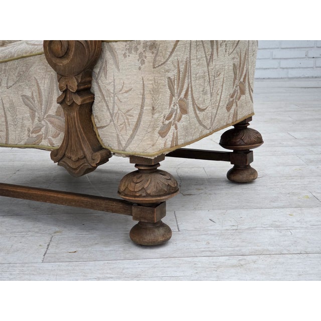 1960s, Danish armchair. Beige/brown furniture fabric, carved oak wood, brass springs in the seat. Chair was reupholstered...