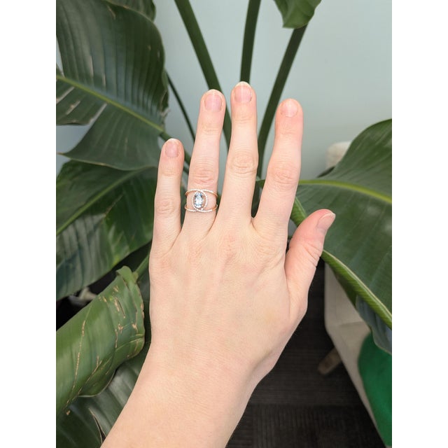 Elegant 1.4 ct oval aquamarine framed by shimmering natural diamonds in a solid 14k gold setting—classic beauty with...