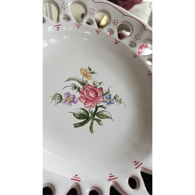 Beautiful hand painted plate or platter made to be hung with interesting pierced pattern around the outer rim and...