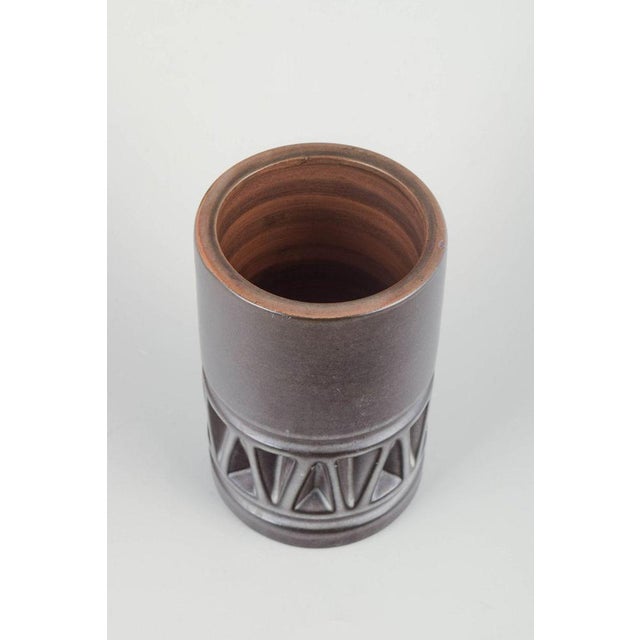 Irma Yourstone for Upsala Ekeby Vase, 1960s. Tall cylindrical stoneware vase with stylised geometric relief, glazed in...
