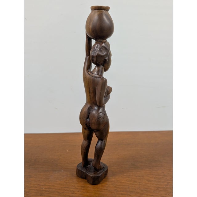 Embrace the timeless allure of authentic tribal artistry with this magnificent handmade African sculpture, a striking...