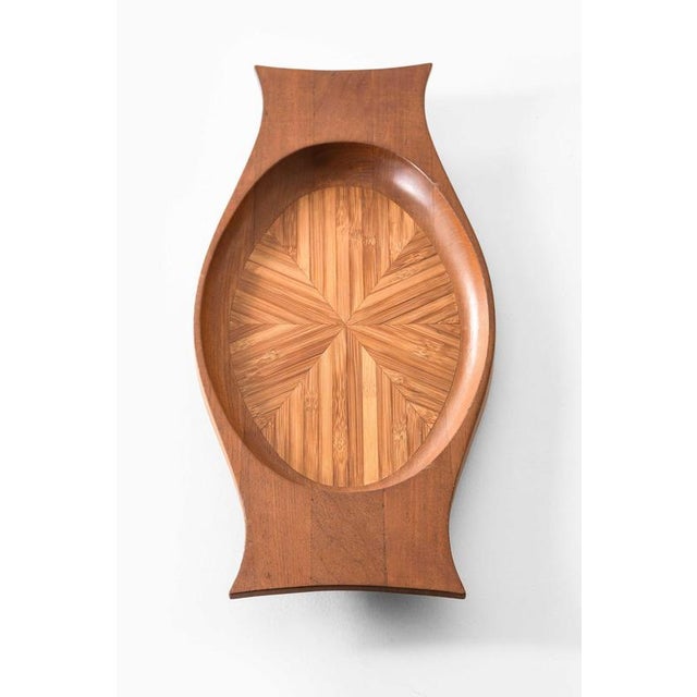 This serving tray, designed by jens quistgaard and produced by nissen in denmark during the 1950s, is a refined example of...