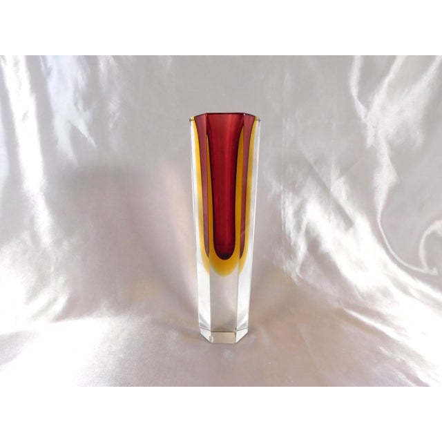 This is a six sided heavy crystal vase. It has dark pink on the inside with yellow outside of that. The vase has no...