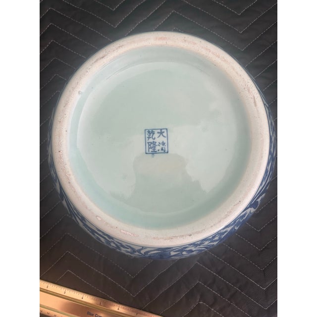 Beautiful vintage Chinese blue-and-white porcelain fishbowl or jardinière featuring an elaborate underwater scene of fish...
