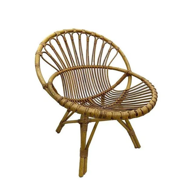 Rattan children's chair with bookshelf, 1960s A Dutch round rattan children's chair with a wall mounted bookshelf from the...