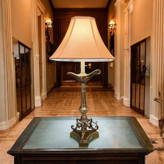 Neoclassical Hollywood Regency Brass Aladdin Table Lamp This early 20th century multi-tiered tall lamp reaches 33” to...