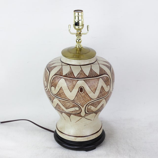 This striking pair of vintage ceramic table lamps features a classic ginger jar silhouette elevated by a bold, earthy...