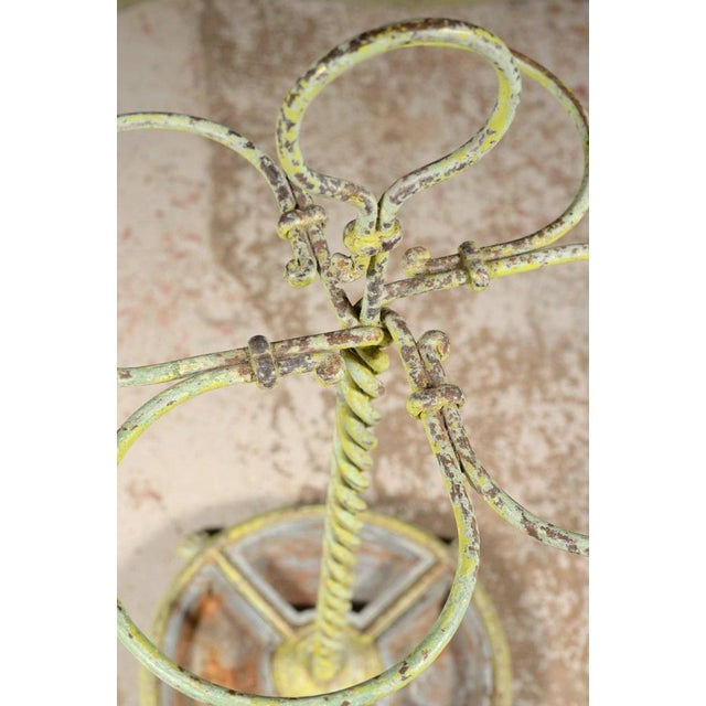 An unusual late 19th or early 20th century four division wrought iron stick stand in lovely original patinated verdigris...