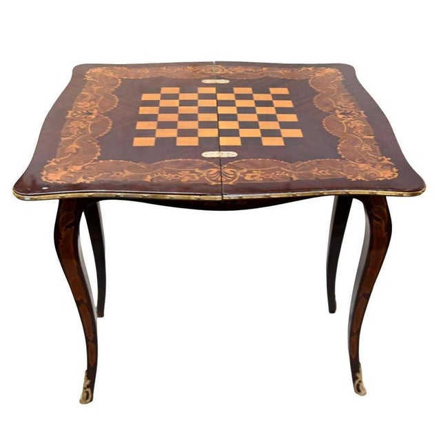 Elegant Louis XV style fold-over games table with elaborate floral marquetry The shaped top features a central musical...