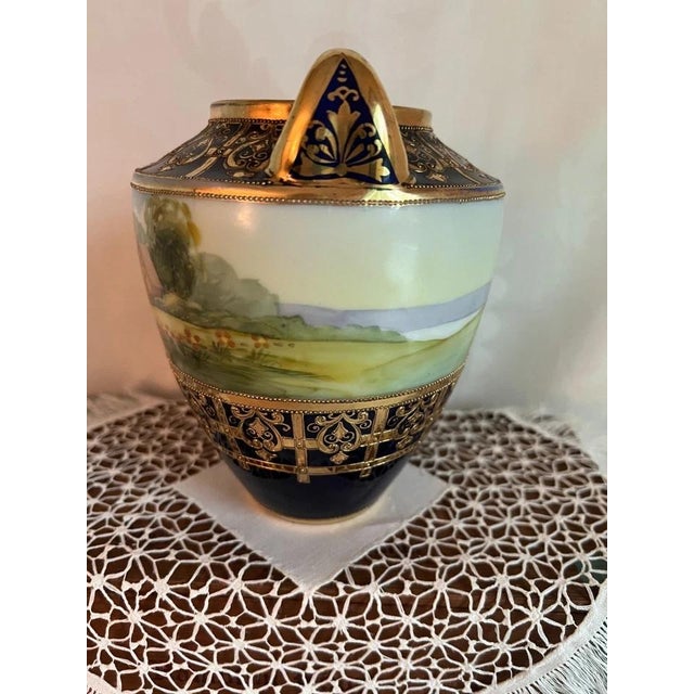A striking antique Nippon porcelain vase dating to approximately 1891–1911, featuring a deep cobalt blue finish, hand-...