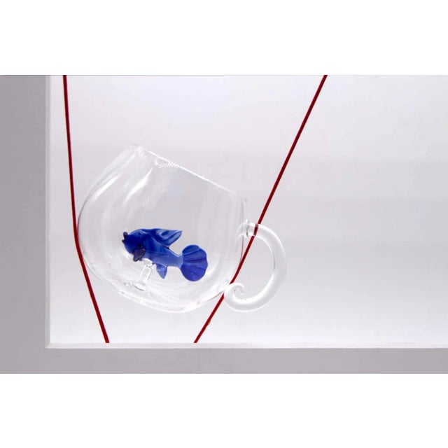 Set of 2 tea cups with a colored fish inside. Handmade by Venetian glass masters. Handmade in Venice by two expert...