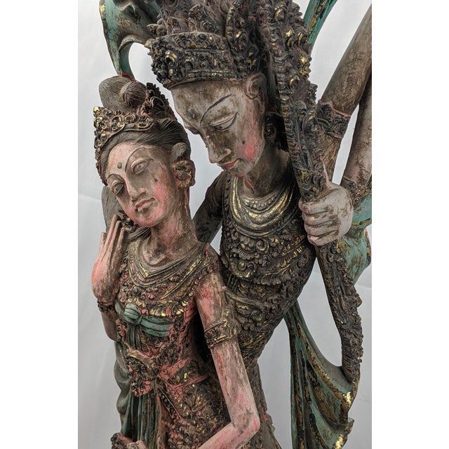 A commanding vintage Balinese figural sculpture, intricately hand-carved from wood and finished in time-softened...
