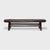 A low daybed step from the mid-19th century, featuring an elongated plank top with rounded ends and short splayed legs...