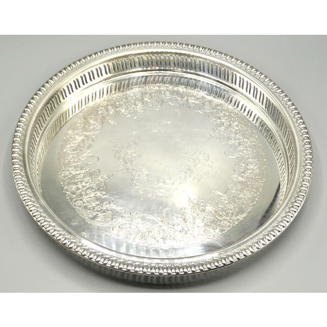 Mid Century silver plate barware drinks serving tray. It features a lovely pierced gallery and ornate etched work. It is a...