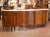 This substantial antique French enfilade, crafted in Provence circa 1920, showcases the elegance and movement of the Louis...
