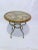 This is a decorative accent table with leather map top and pewter fished called Caribbean gold metal frame. Designed by...