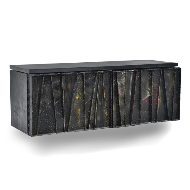 A sublime piece of functional sculpture by Paul Evans, this 1968 Deep Relief cabinet features a wall-mounted case with...