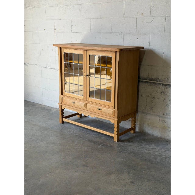 This distinctive display cabinet features leaded glass doors and two felt-lined lower drawers. Built with traditional...